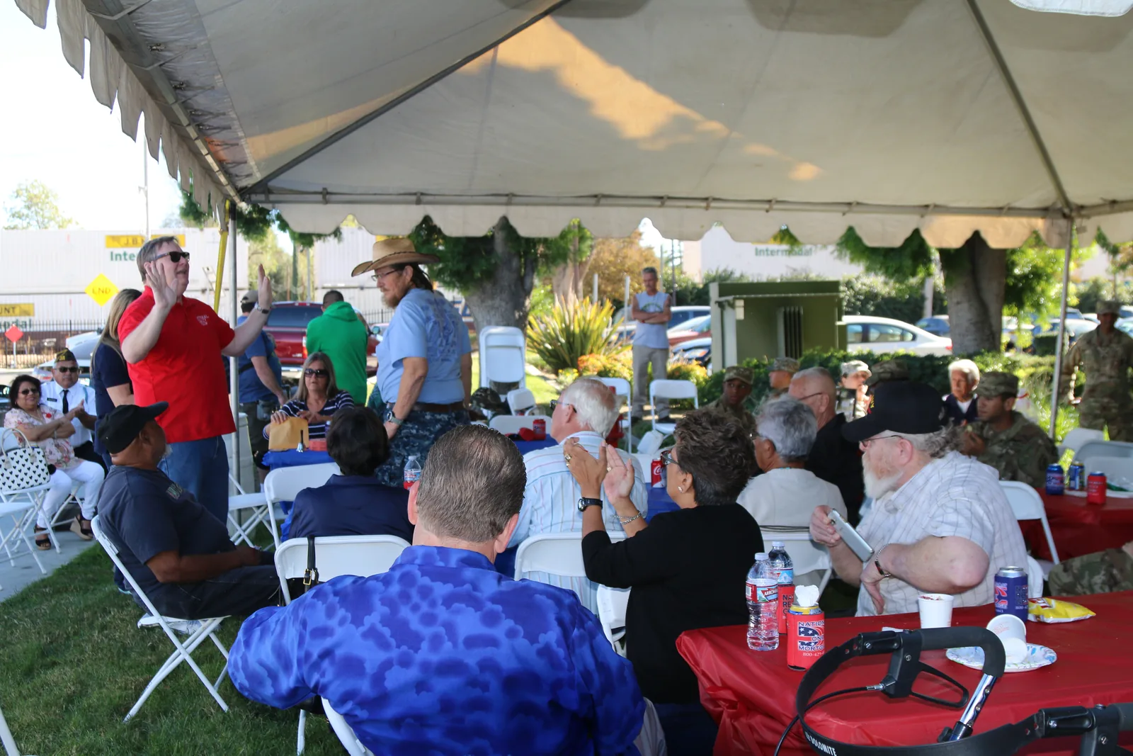 Guests seated under a tent at the National Realty Group veterans appreciation barbecue in Riverside.