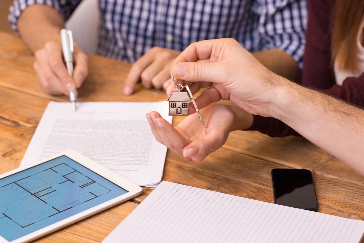 Close up of female hand receiving keys from house broker